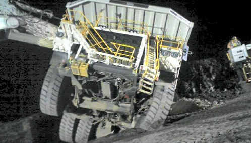 The driver of this rear dump truck escaped uninjured after partly reversing into a blast hole during a night shift at Goonyella Riverside coal mine on Monday. The driver of this rear dump truck escaped uninjured after partly reversing into a blast hole during a night shift at Goonyella Riverside coal mine on Monday.